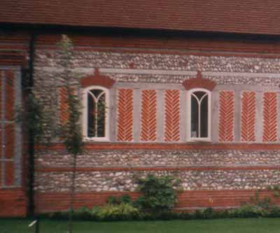 Small arched windows in a flint wall, West Sussex, England